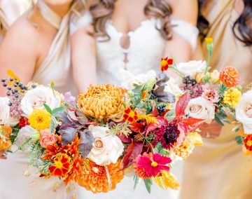 Bridesmaids holding colorful bouquets before a waterfront wedding at Amarante's Sea Cliff