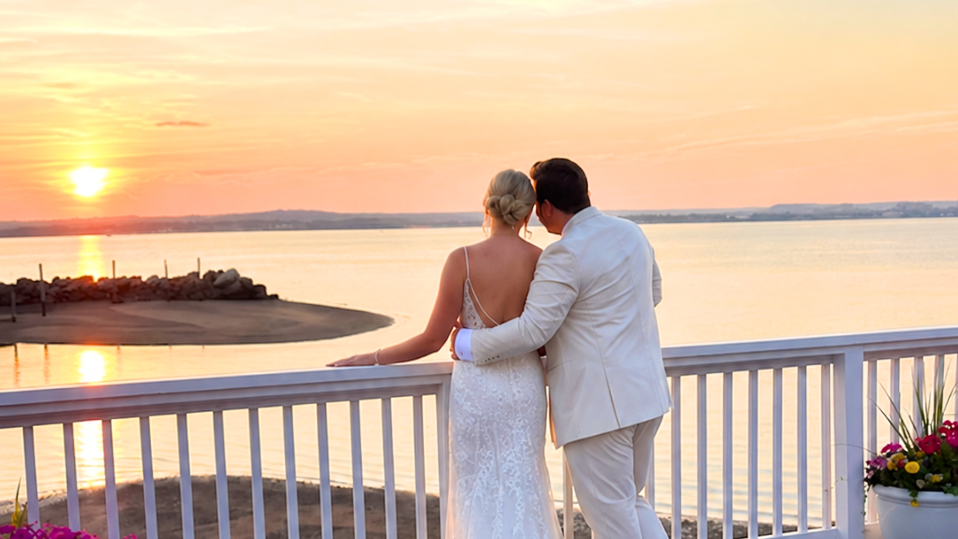Bride and groom embracing at sunset overlooking Long Island Sound at Amarante's Sea Cliff