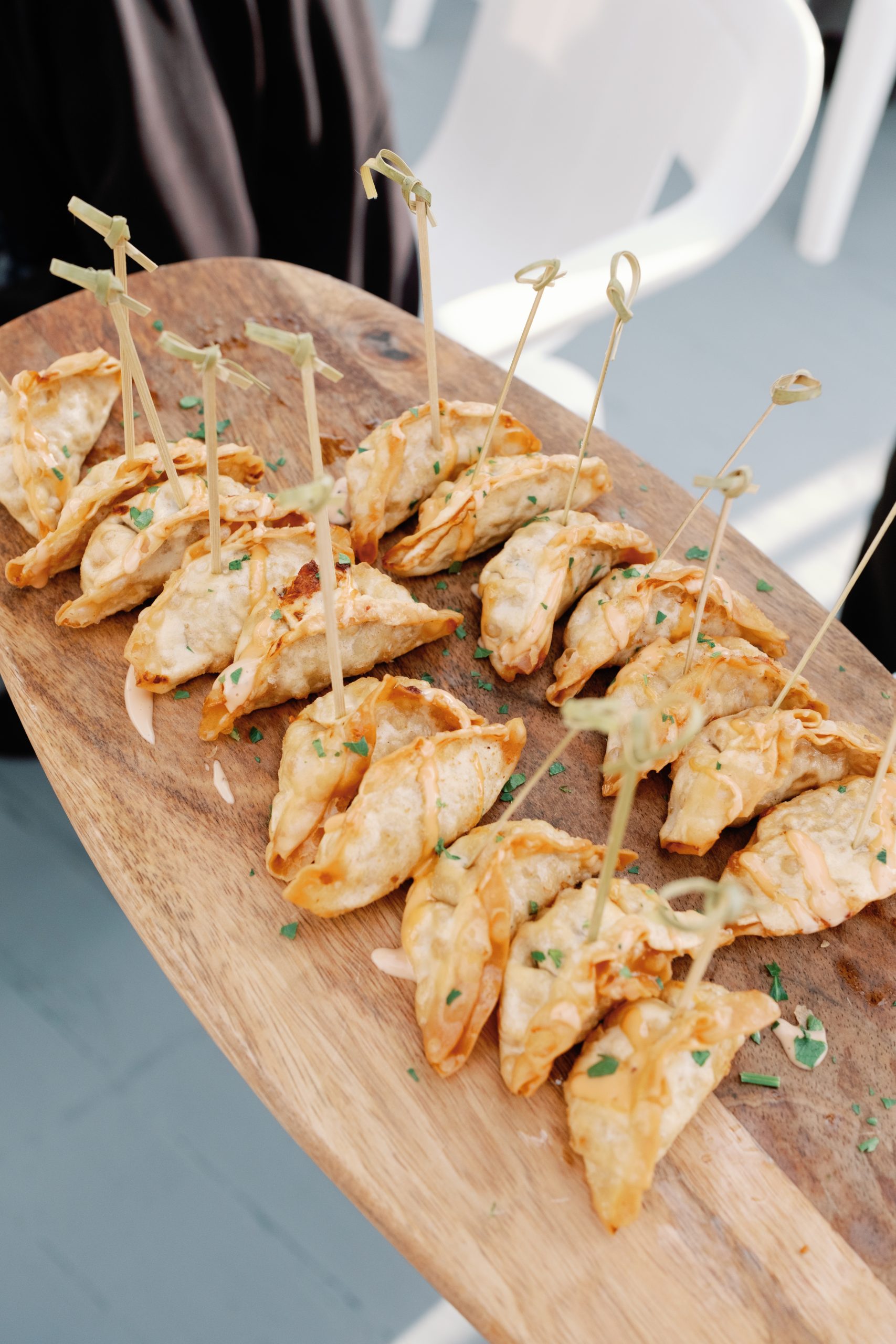 Passed hors d’oeuvres beautifully arranged on a wooden serving board at Amarante’s Sea Cliff