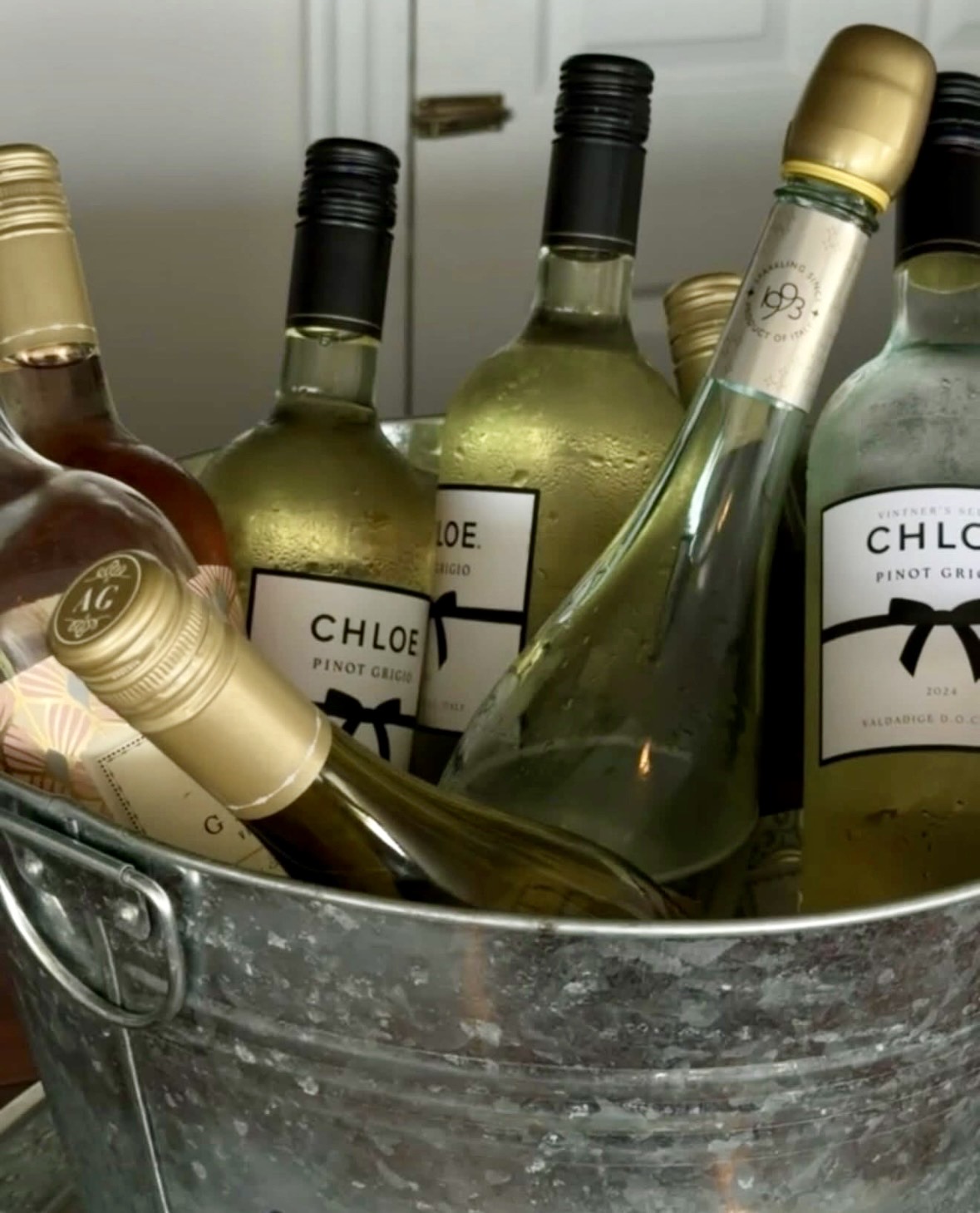 Chilled bottles of wine arranged for guests at a bridal shower.