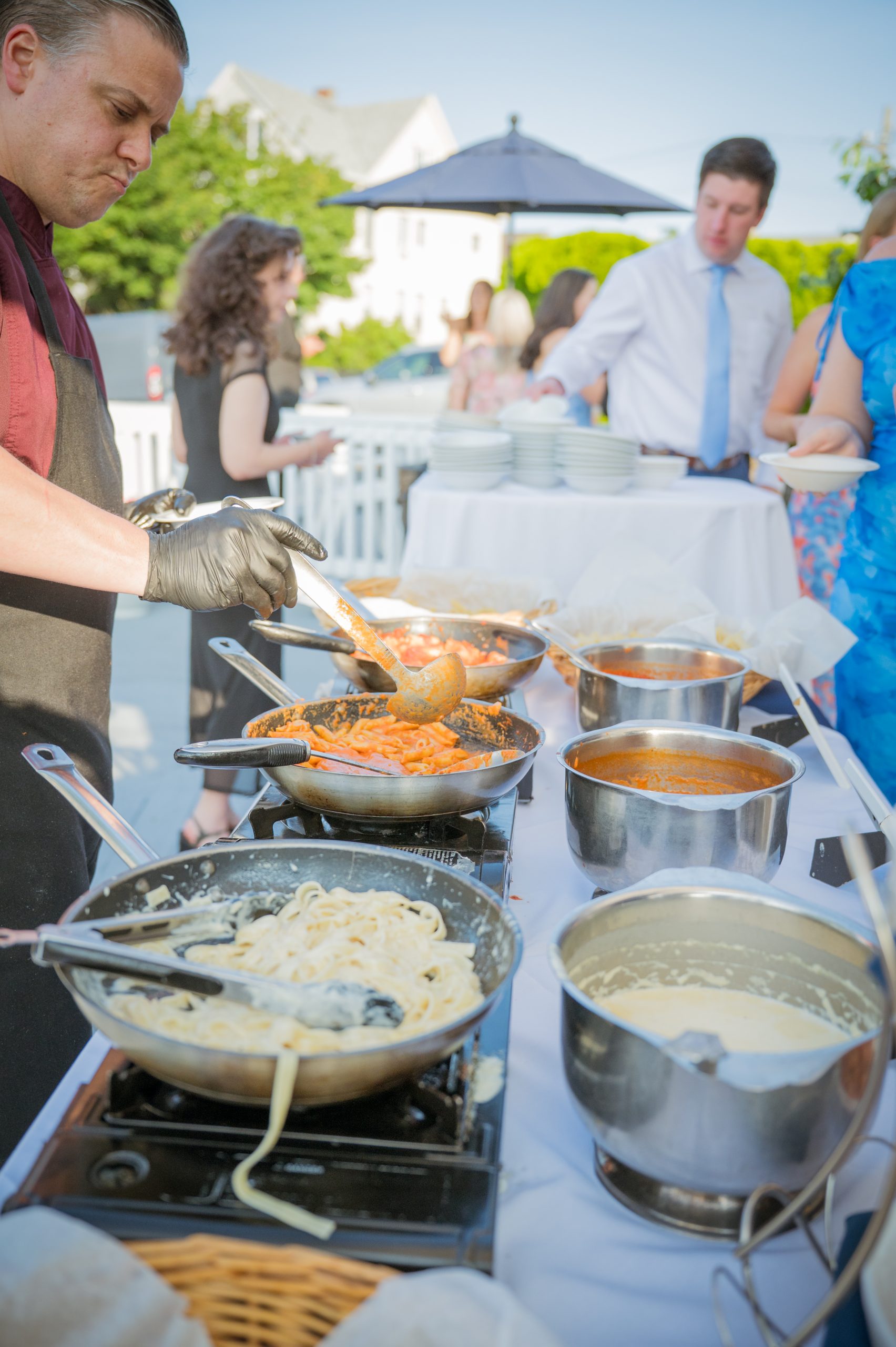 Outdoor buffet station with chefs preparing food for a waterfront event at Amarante’s Sea Cliff